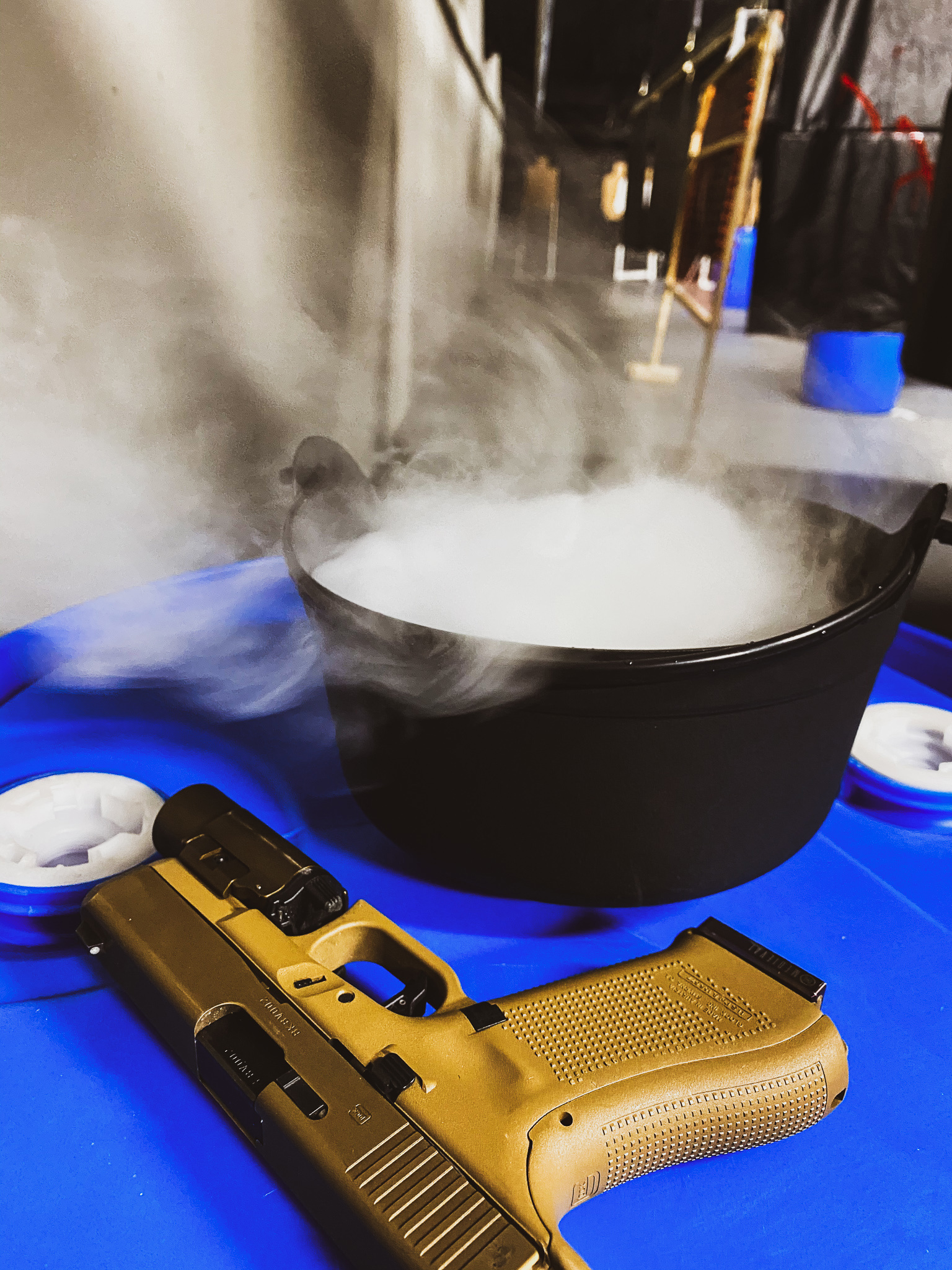 Fog machine going beside a pistol on the bench