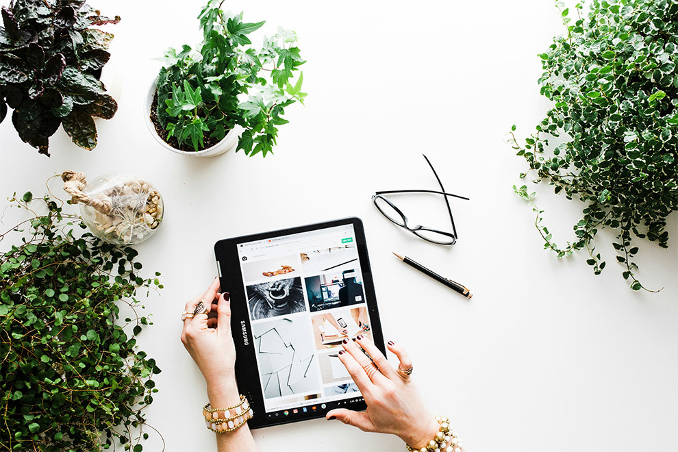 A woman working on her blog on her tablet.