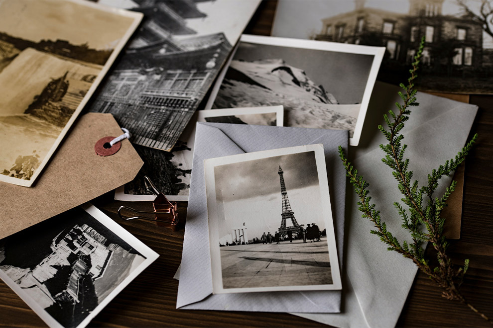 Photos, letters, and notes spread across a desk.