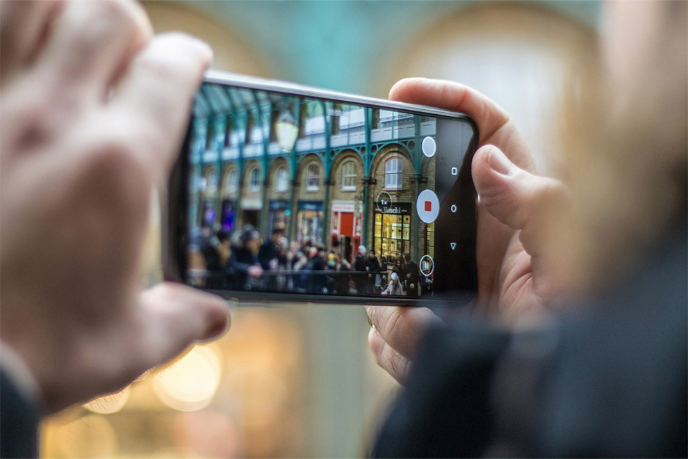 A person taking a picture with their smartphone.